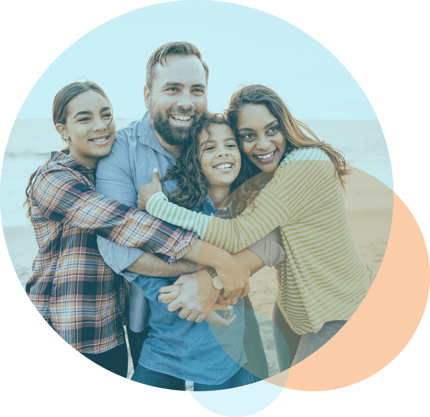 father and mother hug preteen and teenage daughters